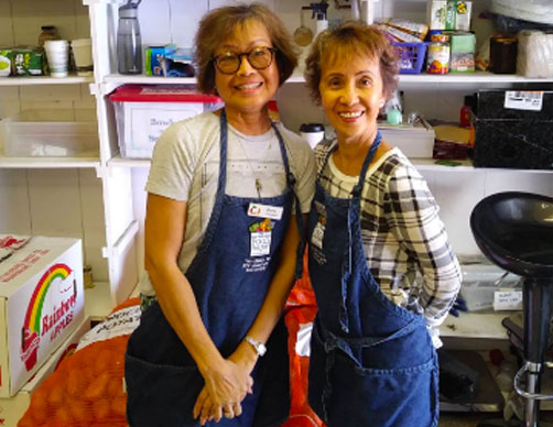 Two female volunteers smiling